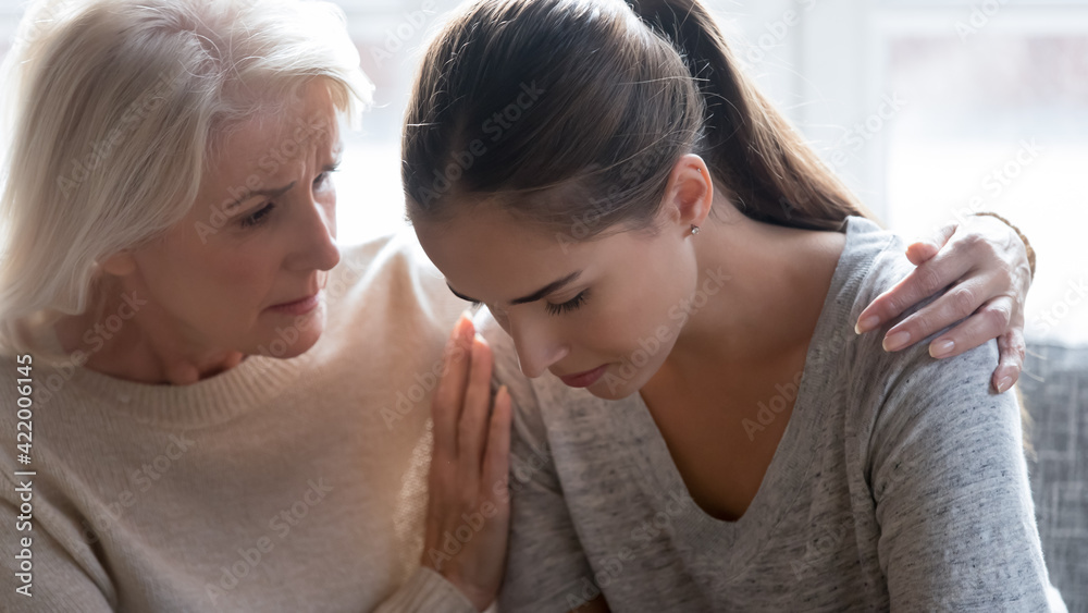 Loving old Caucasian mom hug comfort unhappy stressed millennial grownup daughter feeling sad lonely. Caring supportive elderly 60s mother embrace caress upset adult child. Family support concept.