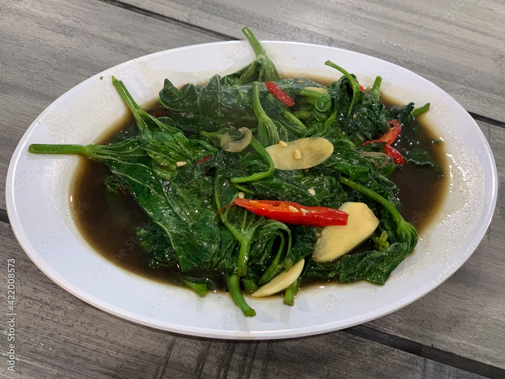 Cah kangkung, kangkong, or water spinach stirred. Cah kangkung, kangkong, or water spinach stirred.