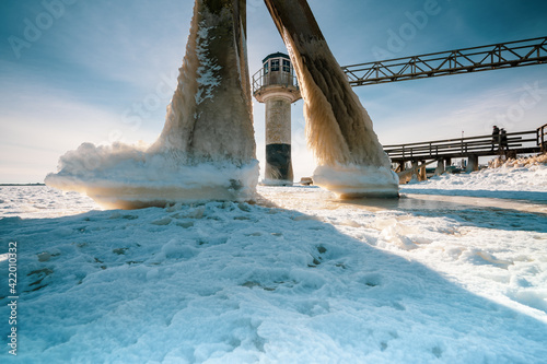 Light beacon or lighthouse in winter landscape at a dutch lake photo