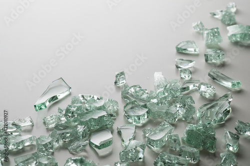 Fototapeta Naklejka Na Ścianę i Meble -  Fragments of broken glass mint color on a white background. Place for text.
