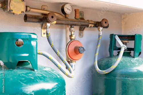 Obraz na plátně Close up on two gas cylinders connected to the LPG regulator and to the residual gas detector