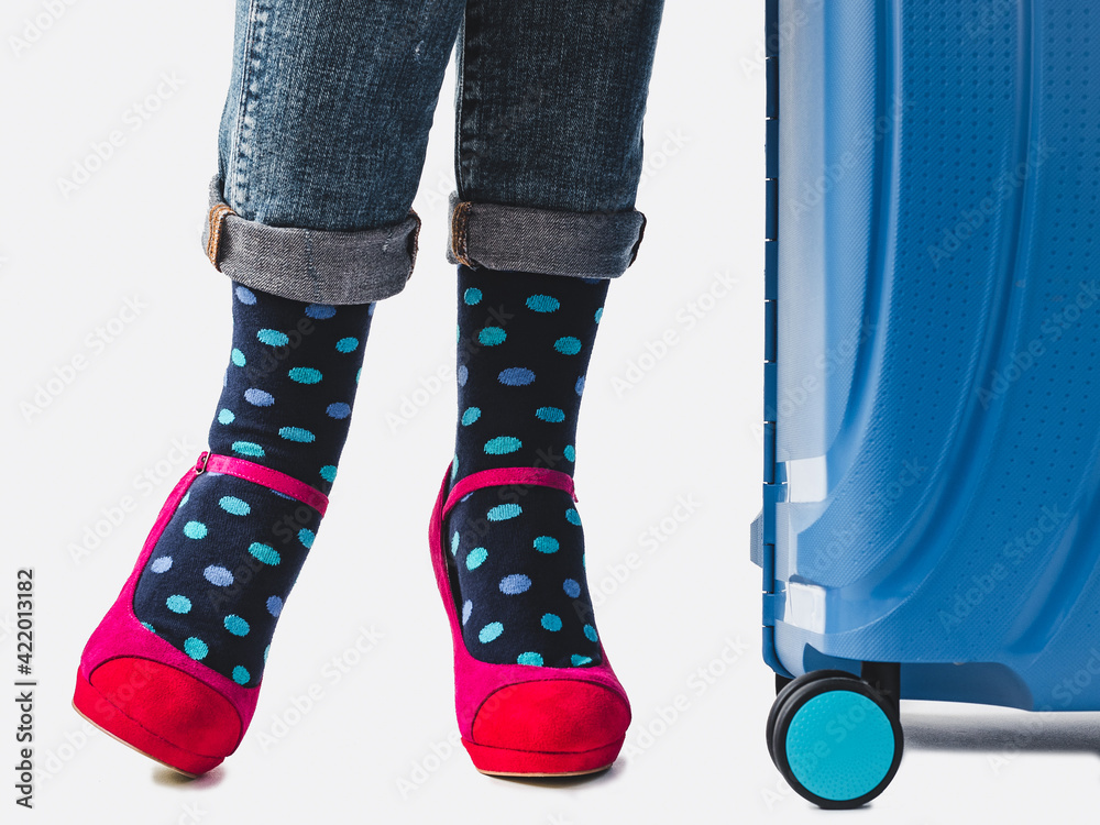 Women's legs, trendy shoes and bright socks. Close-up. Style, beauty and elegance concept