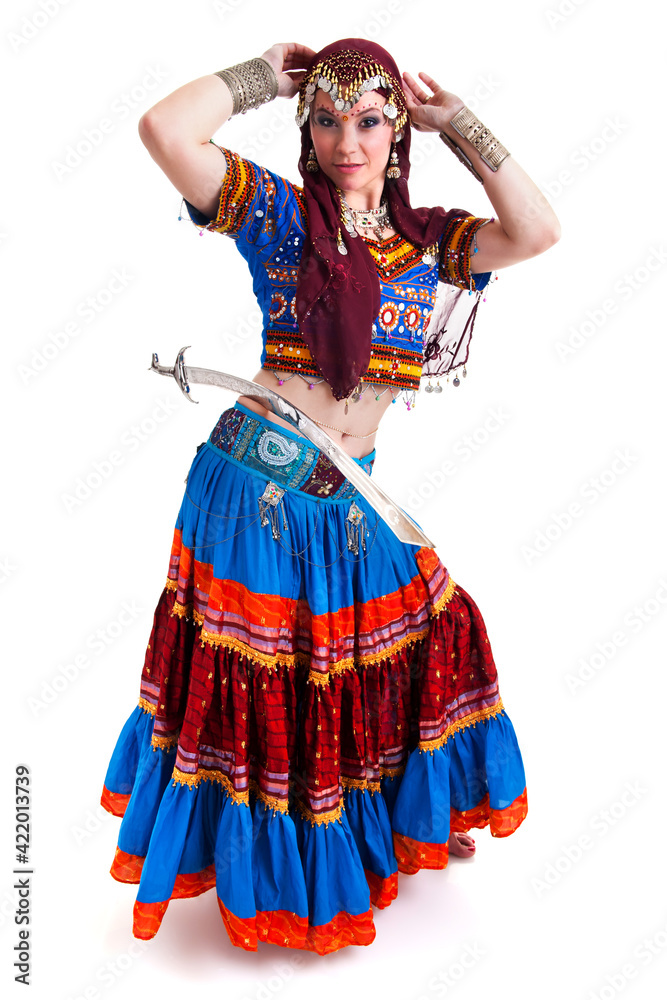 Fototapeta premium Beautiful young female belly dancer with red a blue dress and sword