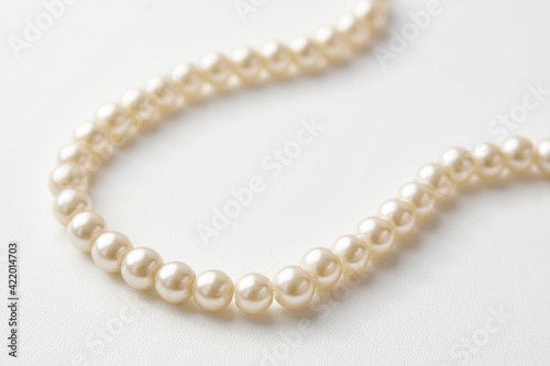 Pearl necklace on white background, close-up