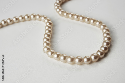 Pearl necklace on white background, close-up