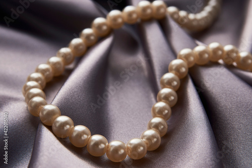 Pearl necklace on black background, close-up