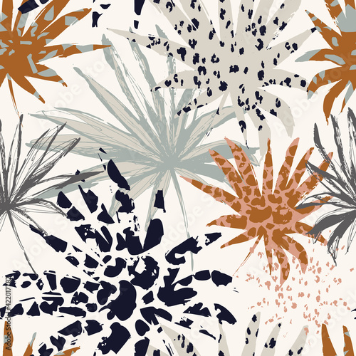 Abstract palm leaves filled with animal print. Modern trendy tropical seamles...