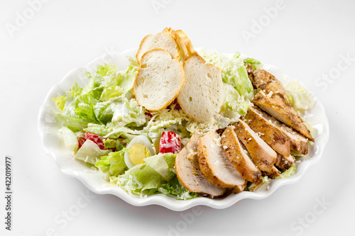 Isolated russian style caesar chicken salad on the white background