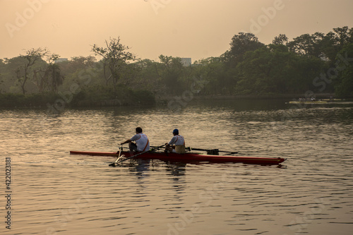 20th MaTwo old men rowers resting while rowing in the morning at Rabindra Sarobar lake  Kolkata. Concept of healthy living.