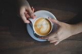 women enjoy drinking coffee at a cafe while having coffee Cup of hot cappucino