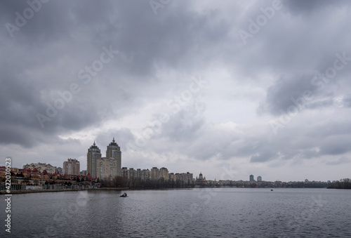 Cloudy landscape with dark sky on Obolon in Kyiv