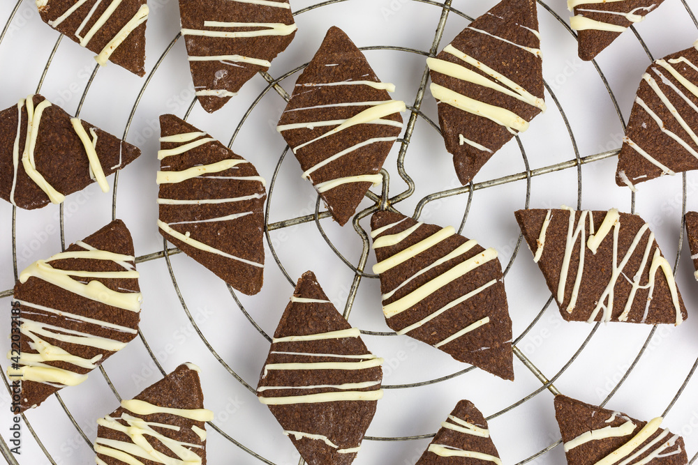 cocoa shortbread diamond cookies with white chocolate on a cooling rack ...