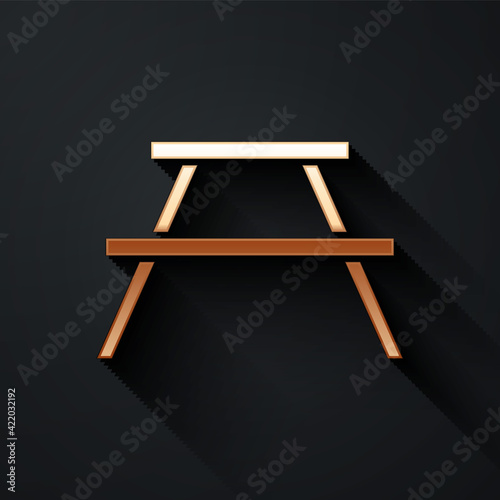 Gold Picnic table with benches on either side of the table icon isolated on black background. Long shadow style. Vector