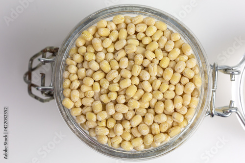 dried urad dal beans in a glass jar photo