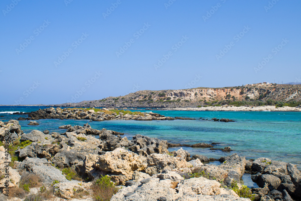 The other side of Elafonisi beach, a stone beach overlooking the blue sea. Crete island, Greece
