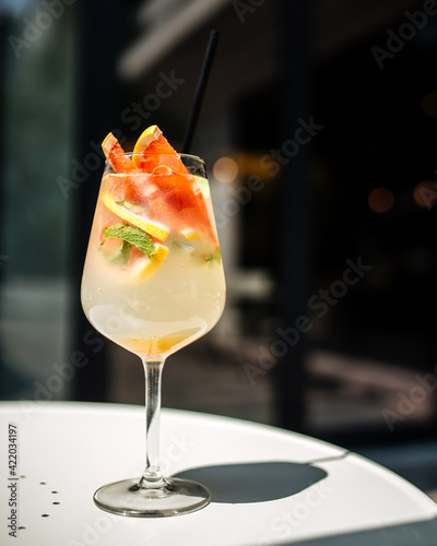 Fresh citrus summer alcoholic cocktail in a wine glass photo