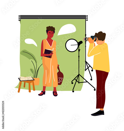 Cartoon model at photo studio. Vector professional photographer occupation, man taking pictures with professional camera and light equipment, woman posing, photoshoot simple illustration