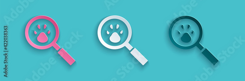 Paper cut Paw search icon isolated on blue background. Magnifying glass with animal footprints. Paper art style. Vector