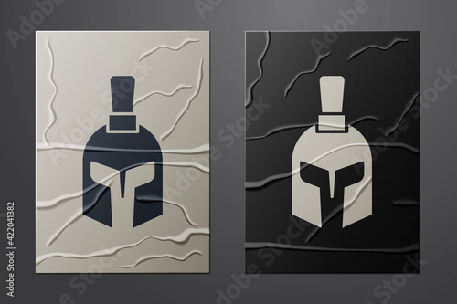 White Greek helmet icon isolated on crumpled paper background. Antiques helmet for head protection soldiers with a crest of feathers or horsehair. Paper art style. Vector