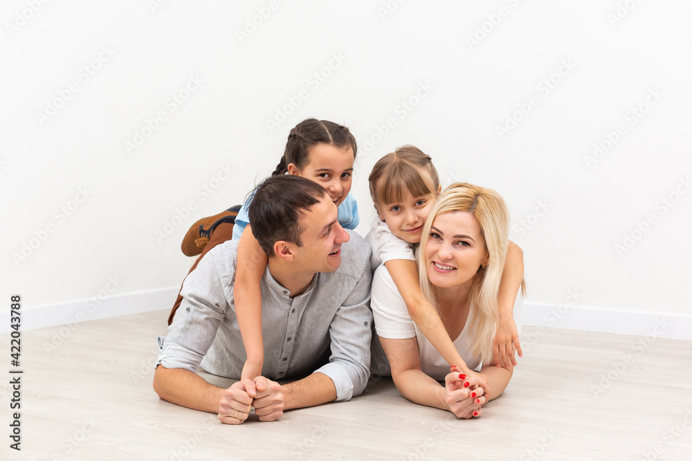 Smiling young parents and their children are very happy, they are at home Smiling young parents and their children are very happy, they are at home