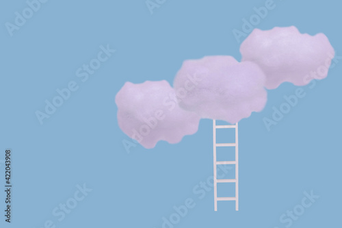 Creative idea with white clouds and ladder on bright blue background.