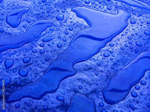 Droplets of rainwater on the blue tarp