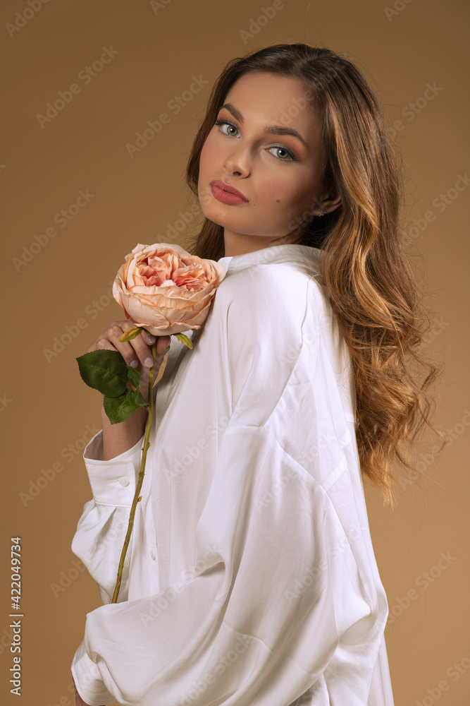 very cute and sweet portrait of girl with rose on beige