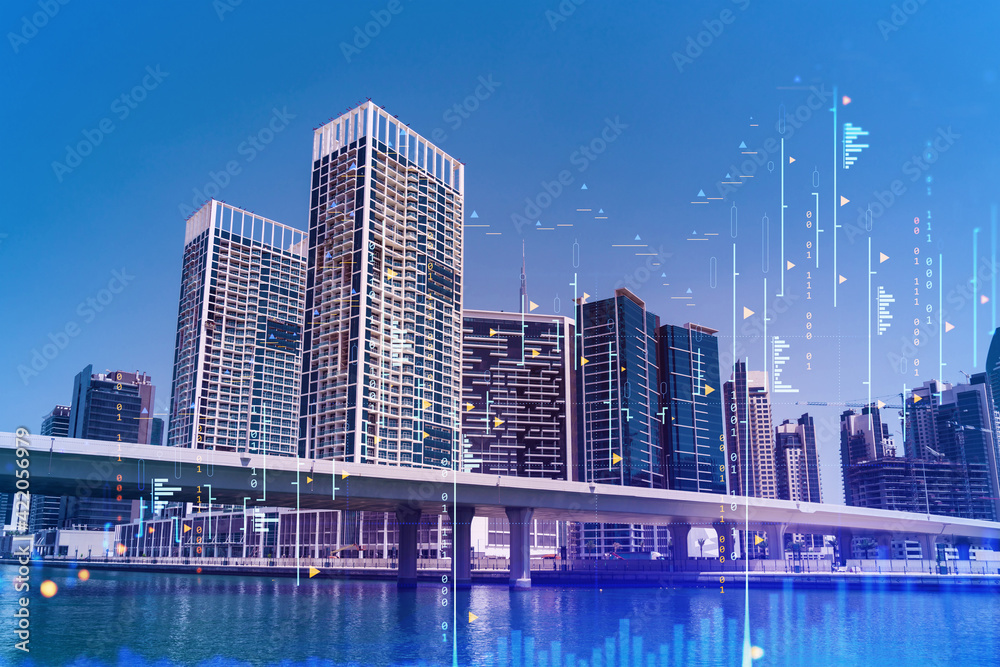 Obraz premium Skyscrapers of Dubai business downtown. International hub of trading and financial services of Western Asia. FOREX graph and chart concept. Double exposure. Dubai Canal waterfront.
