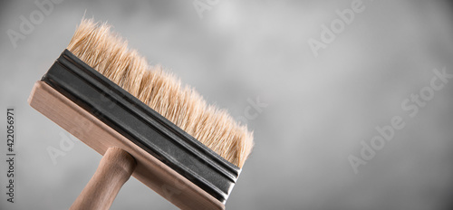 Clean fresh new paint brushes for painting on gray blurred concrete background. Close up with copy empty space for text. Banner for advertising.
