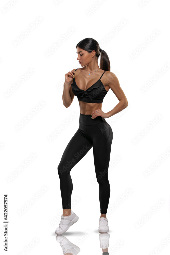 girl in black leggings and a top on a white background girl in black leggings and a top on a white background