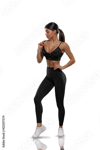 girl in black leggings and a top on a white background