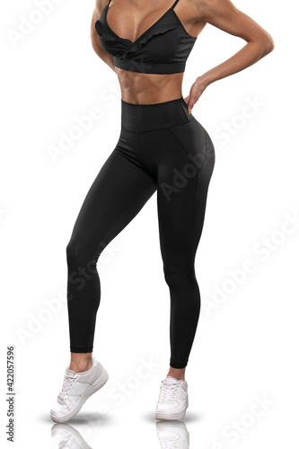 Legs girl in black leggings and a top on a white background