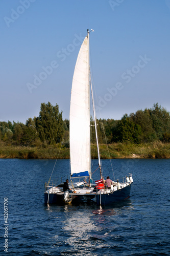 Boat catamaran with sail on the river Lielupe, in Latvia 22 September 2020.