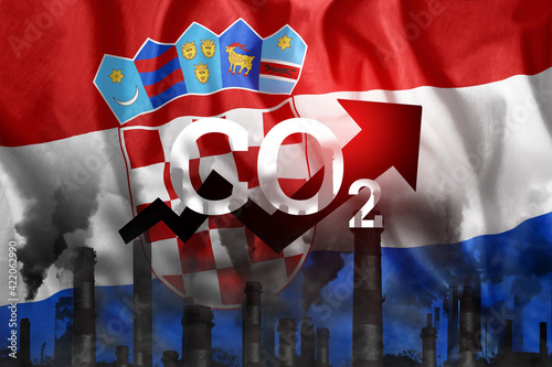 CO2 emissions into the atmosphere. Pipes with black smoke against the background of the Croatia flag. Industrial air pollution concept, Environmental pollution by carbon dioxide.