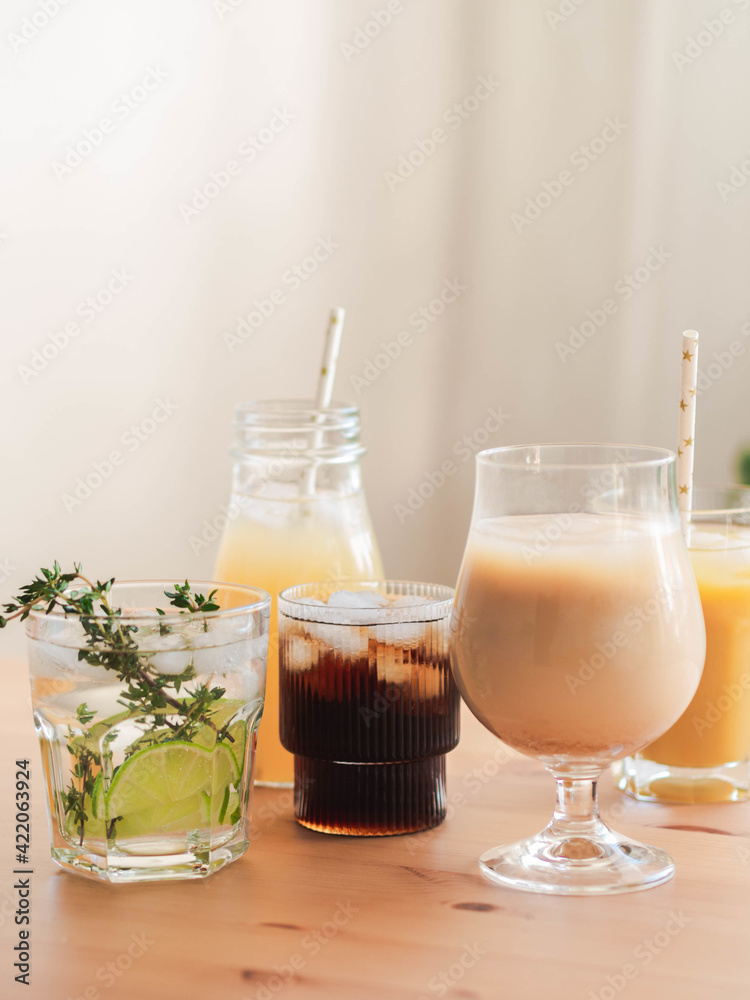 Various refreshing non-alcoholic drinks in glasses with ice.