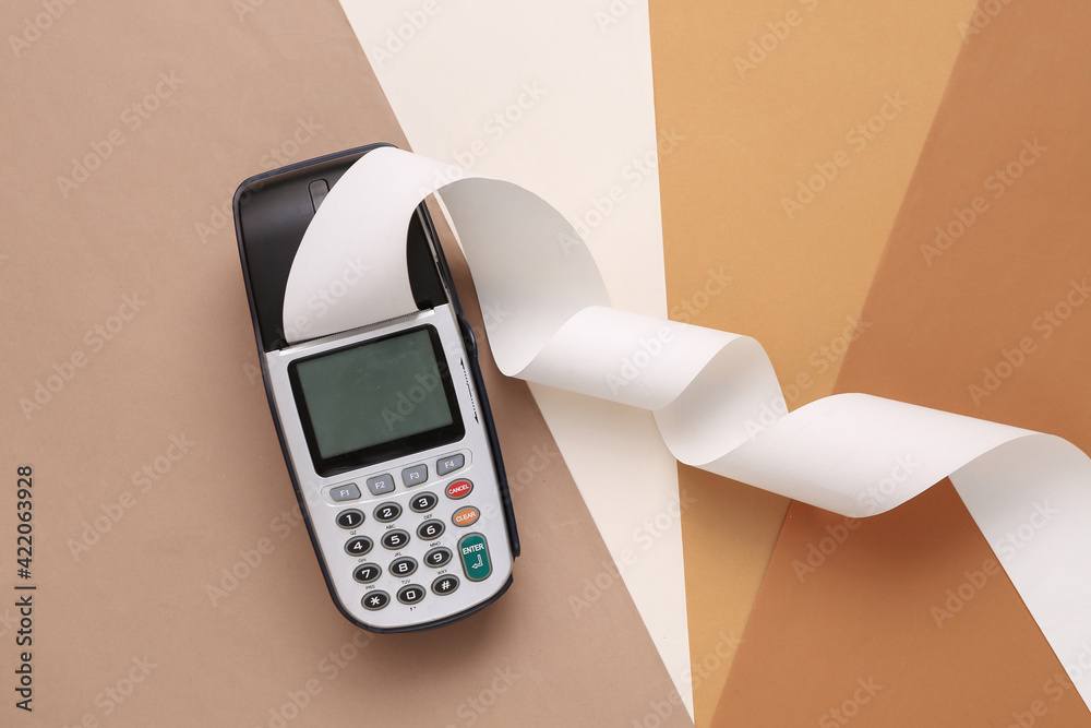 Payment terminal with paper tape on colored background - obrazy, fototapety, plakaty 