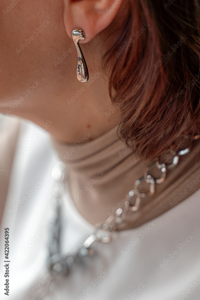 women's earrings, jewelry, earrings at the ear of a beautiful girl, women's accessories, gold earrings,