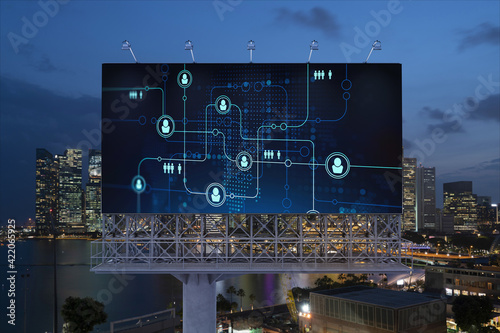 Glowing Social media icons on billboard over night panoramic city view of Singapore. The concept of networking and establishing new connections between people and businesses in Southeast Asia