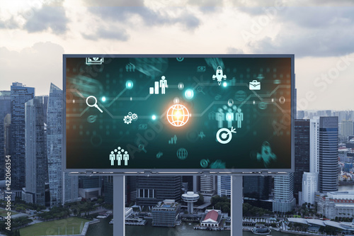 Hologram of Research and Development glowing icons on billboard. Sunset panoramic city view of Singapore. Concept of innovative technologies to create new services and products in Southeast Asia.