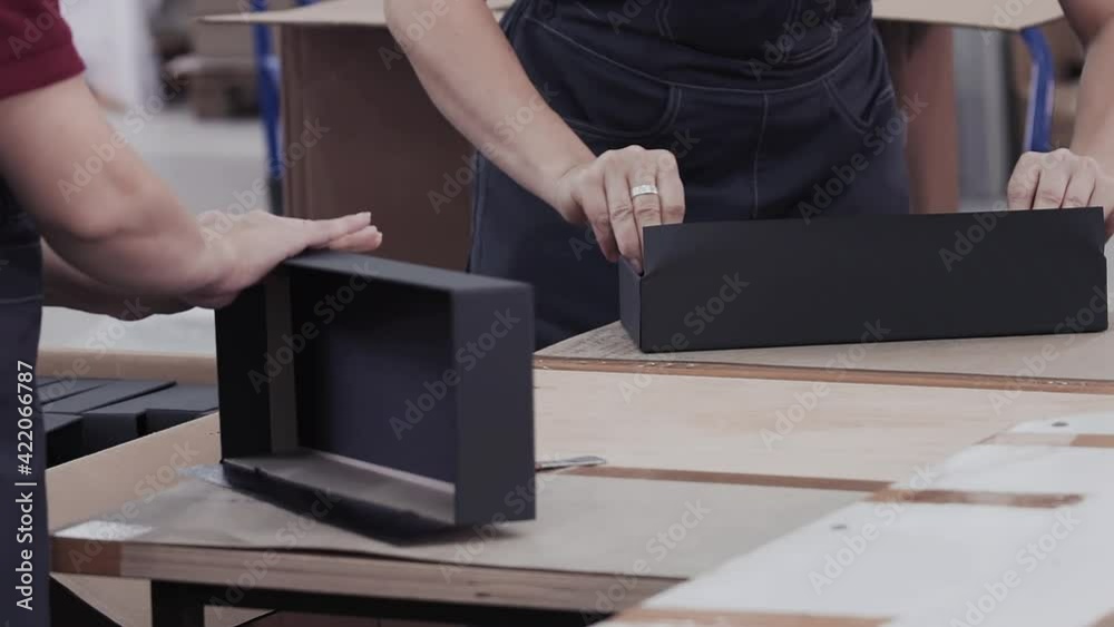 Workers laminated cardboard box. Modern factory of production cardboard box. Manufacture of cardboard boxes from paper. Enterprise for production package Workers laminated cardboard box. Modern factory of production cardboard box. Manufacture of cardboard boxes from paper. Enterprise for production package