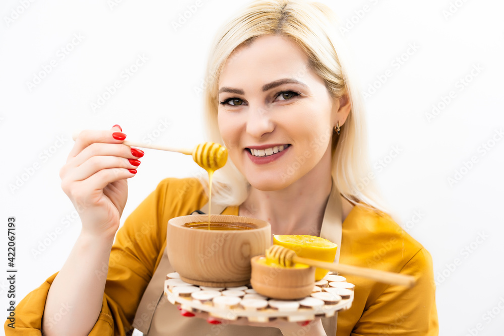 smiling young woman with bowl of honey on white background smiling young woman with bowl of honey on white background