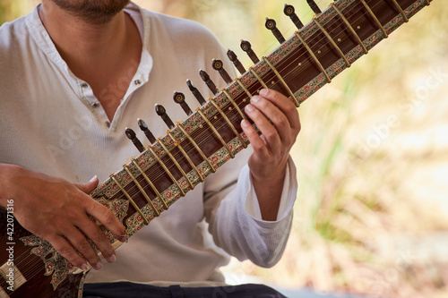 Close-up of a street musician playing Sitar