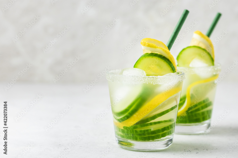 Fototapeta premium Refreshing lemon cucumber summer iced drinks. Space for text.