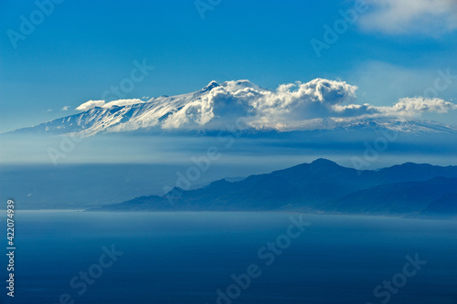 The Strait of Messina seen from Calabria, in the clouds Mount Etna, Sicily, Italy, Europe