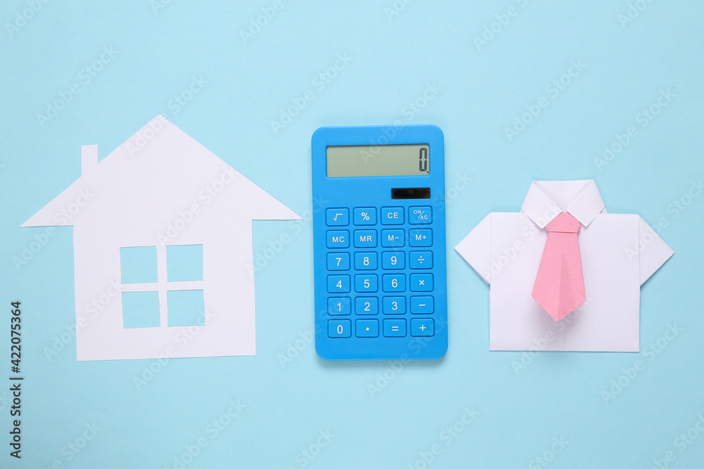 Paper cut house, calculator and origami shirt on blue background Paper cut house, calculator and origami shirt on blue background