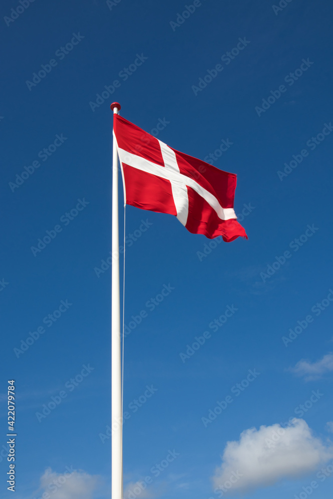 The danish flag with blue sky on background The danish flag with blue sky on background