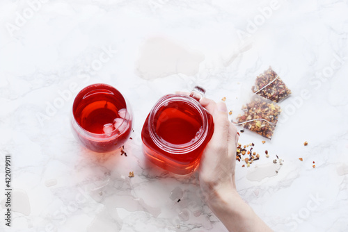 Pink drink with bissap juice, hibiscus and ice for herbal tea or iced tea  photo