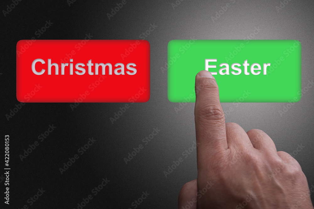 Finger pushing green button with Easter writing, as opposed to red button with Christmas writing Finger pushing green button with Easter writing, as opposed to red button with Christmas writing