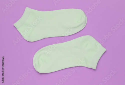 Socks on pink background. Minimalism fashion concept. Pastel color trend.