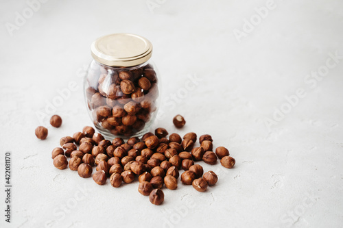 hazelnuts in a jar on a white background